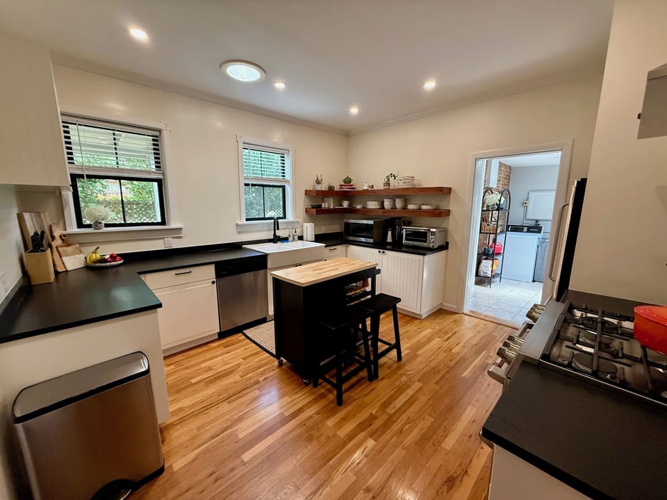 Fully stocked kitchen with GE appliances and adjacent walk-in pantry