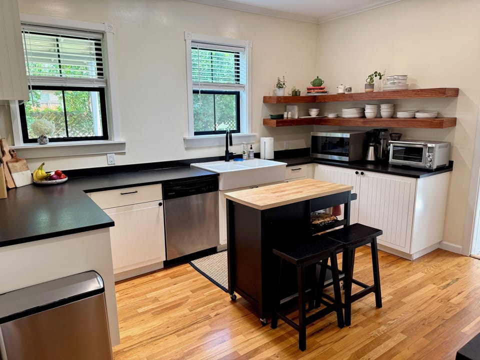 Fully stocked kitchen with GE appliances and adjacent walk-in pantry
