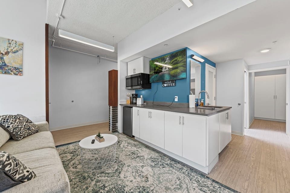 Chic open space w/ seating, kitchenette, TV & natural light—great to relax.