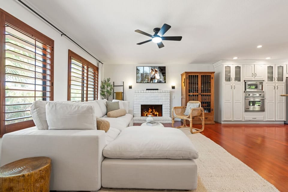 Open living area w/ plush sectional, ceiling fan & warm wood floors, ideal for relaxing between adventures.
