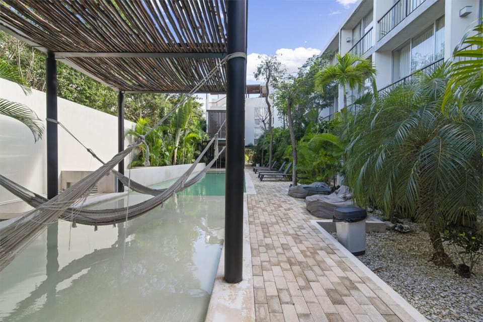 Hammock lounge over water—your tropical chill zone in Tulum.