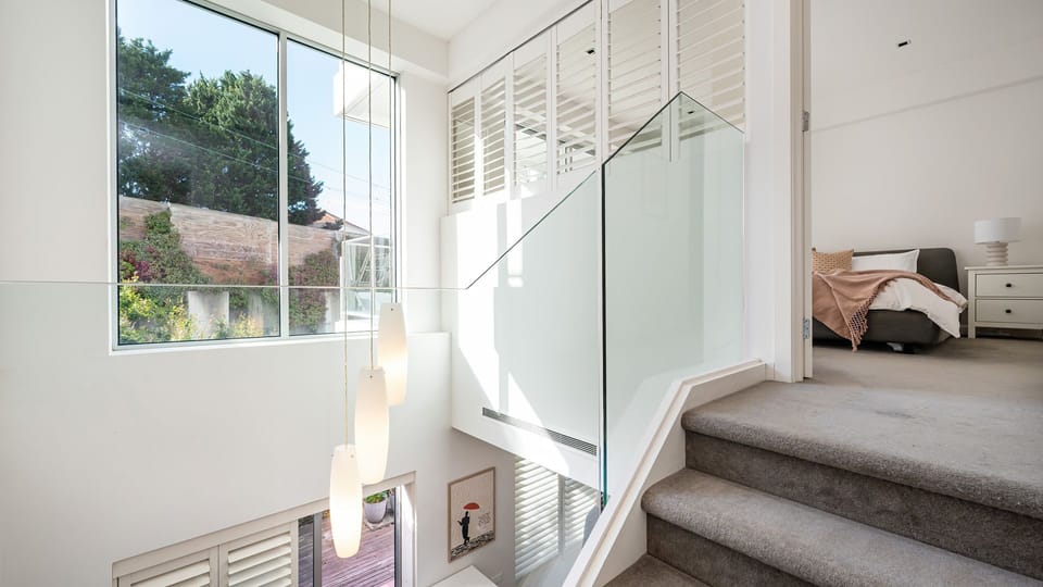 Stairs leading up to the master bedroom with balcony and ensuite