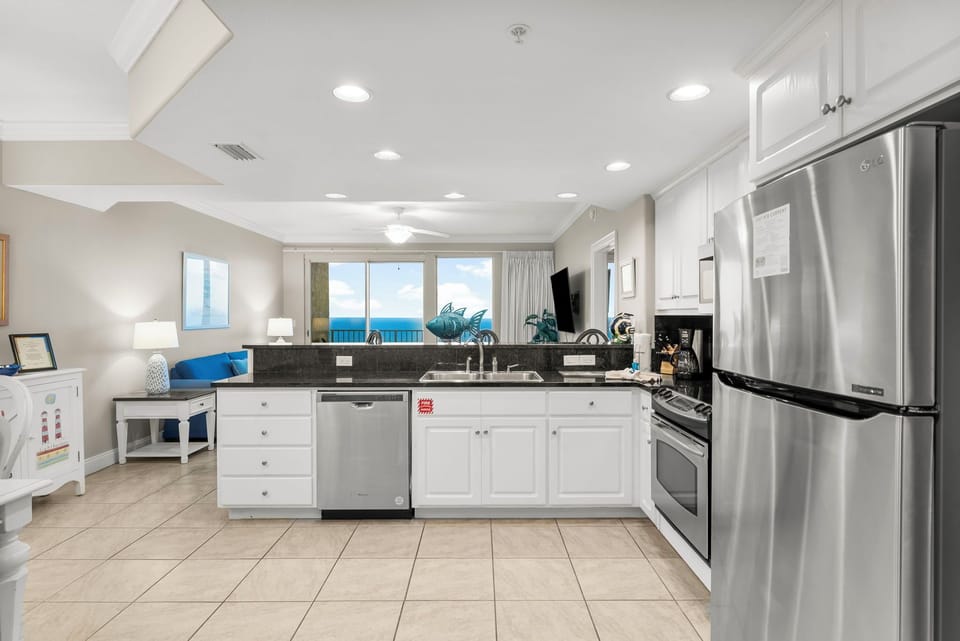 Modern kitchen with stainless steel appliances and ocean views.