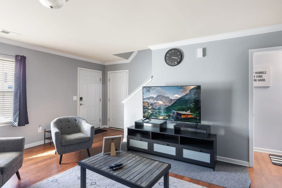 Living Room space with coffee table, pull-out sofa and TV for entertainment