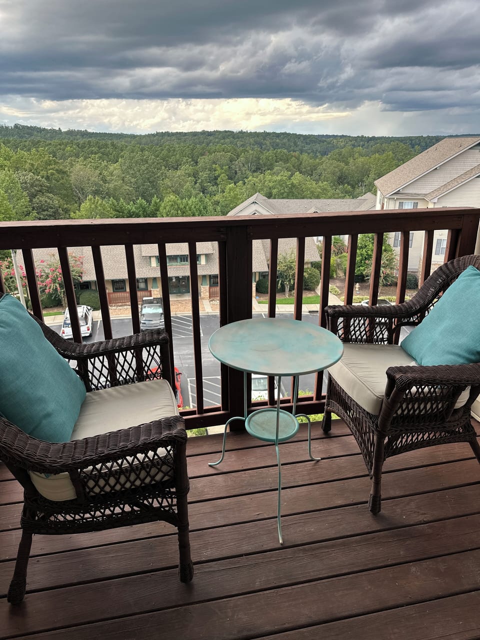 Balcony overlooking clubhouse and pool. Beautiful view of lakefront trees 