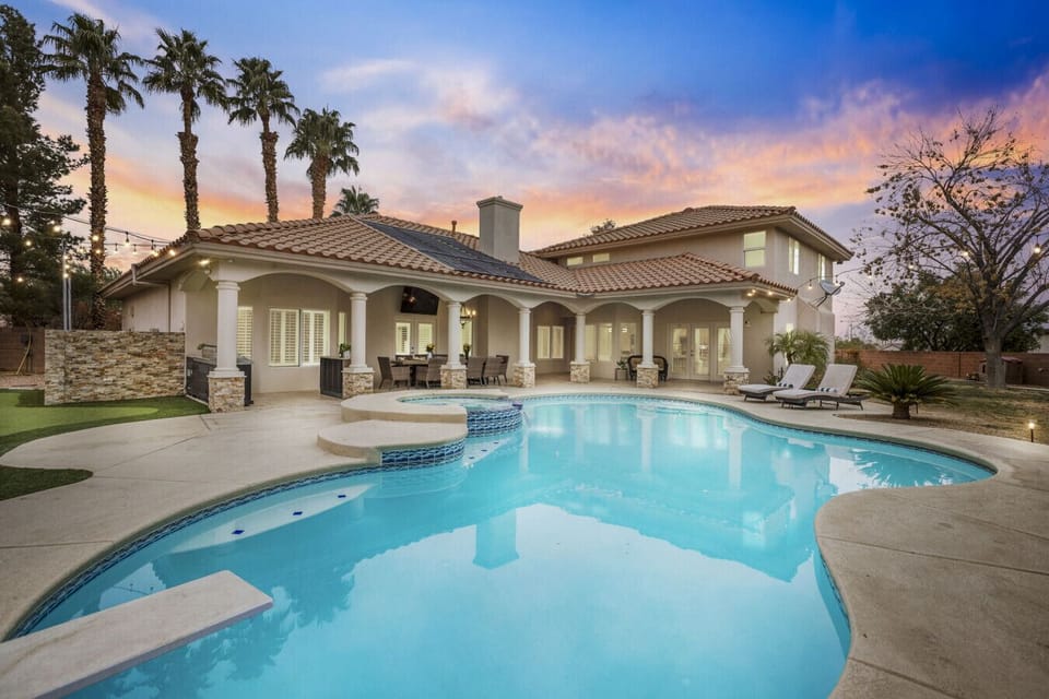 Outdoor Oasis- Dive into relaxation in this stunning poolside retreat surrounded by palm trees.
