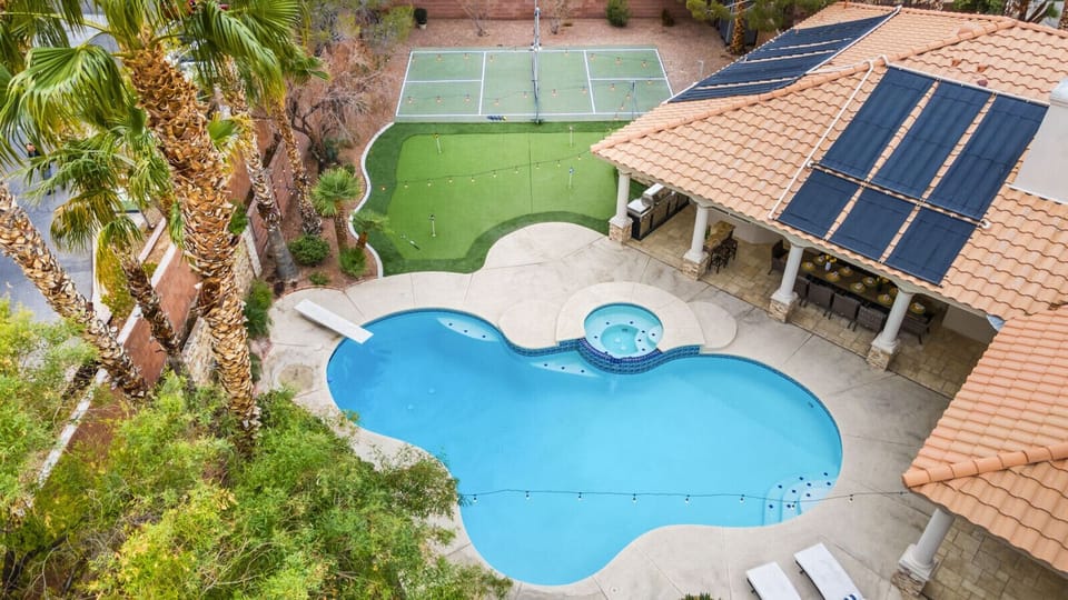 Backyard Oasis! Splash into fun with a pool, spa, and games galore under the Vegas sun.