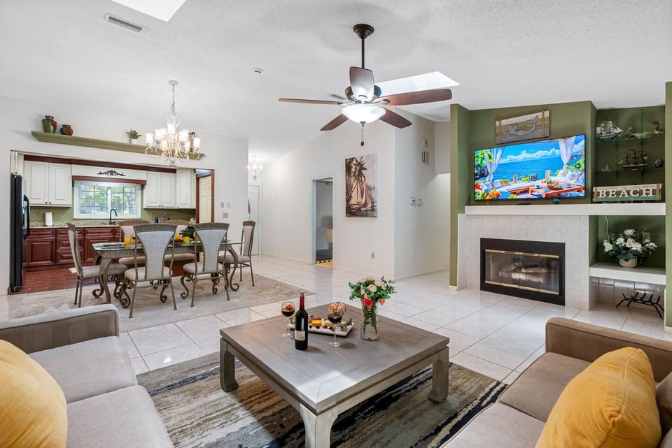 Flanked by a rich green accent wall and built-in shelving, this focal point adds warmth and a touch of sophistication.