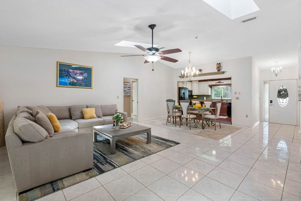 The ambiance is further elevated by the natural light that pours in through the oversized windows, making the room feel airy and bright throughout the day.