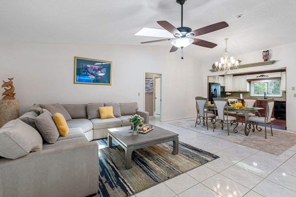 a beautifully styled and spacious living room that seamlessly blends comfort, warmth, and modern design.