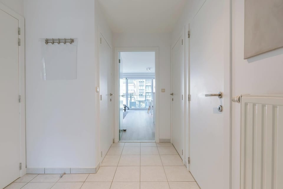 Bright Hallway Leading to Balcony
