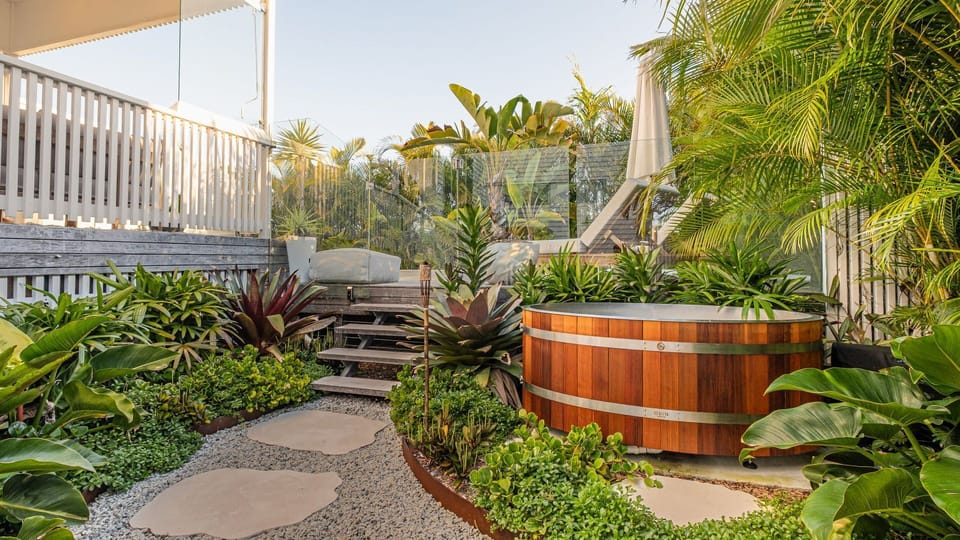 Cedar ice bath tucked in peaceful garden sanctuary