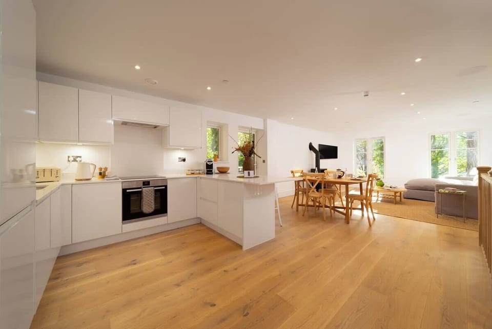 Contemporary open plan living living that leads out onto a spacious patio.