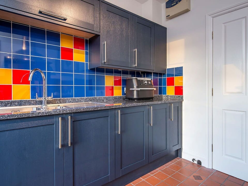 Blue, Kitchen, Flooring, Interior Design, Floor, Countertop, Cabinetry, Tile, Major Appliance, Cupboard