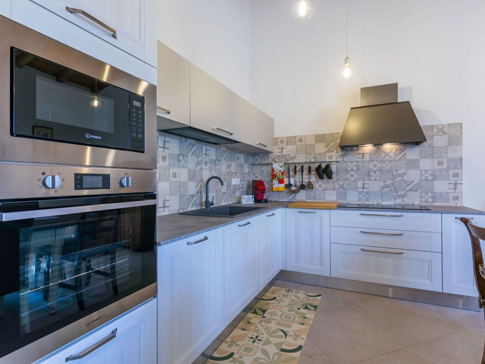 Kitchen Appliance, Kitchen, Countertop, Major Appliance, Cabinetry, Flooring, Kitchen Stove, Interior Design, Stove, Home Appliance