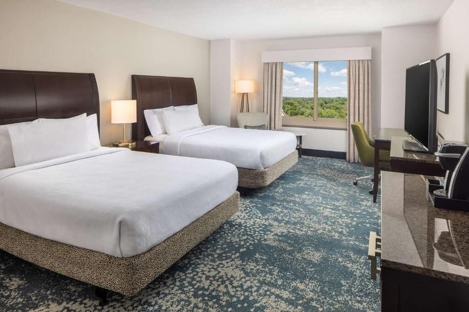 Unwind in bright double-queen comfort with peaceful views beyond.