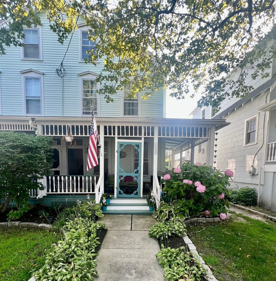 Inviting walkway to front door and screened in porch