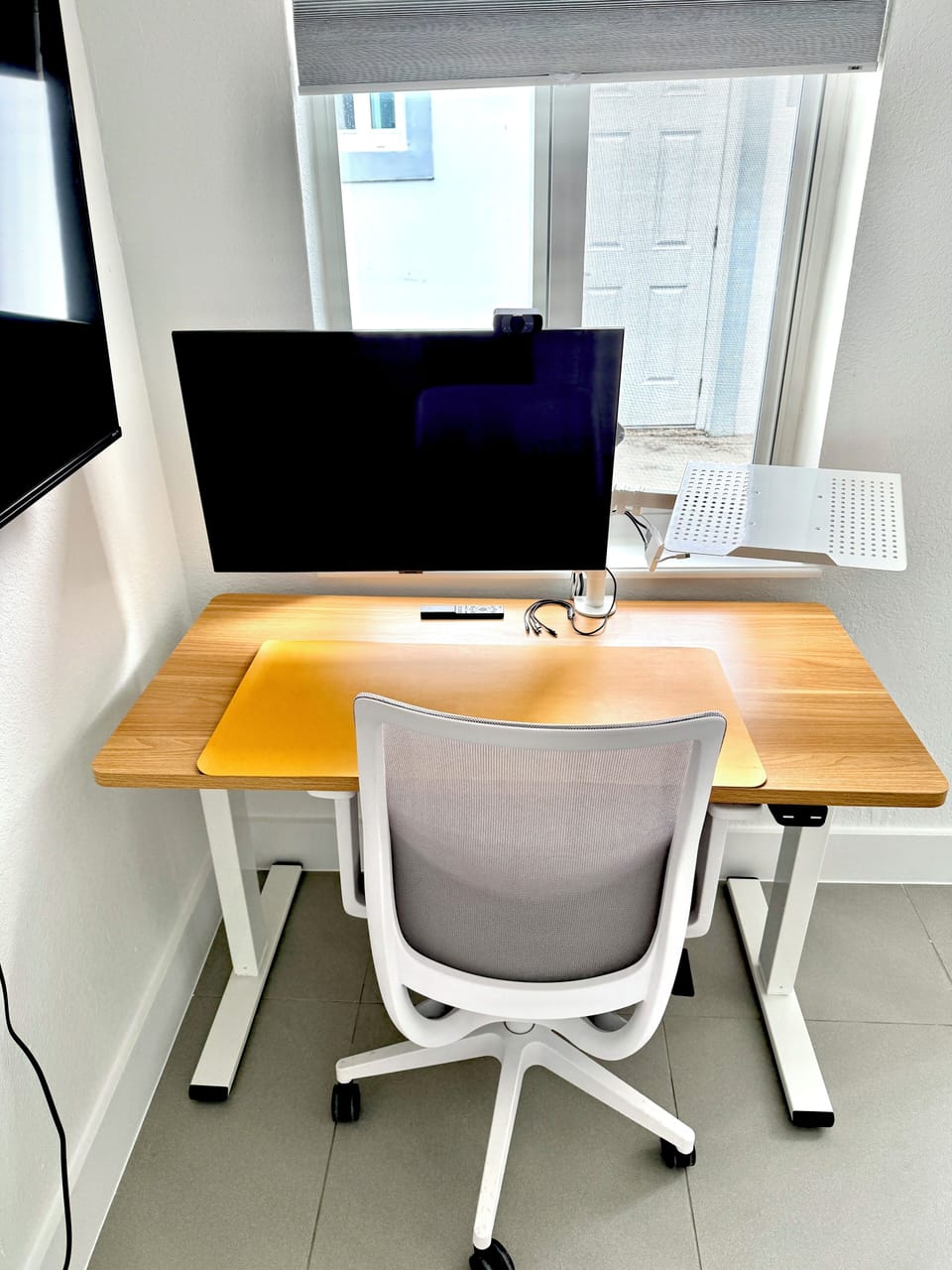 Private desk/workstation with large monitor ready to connect.