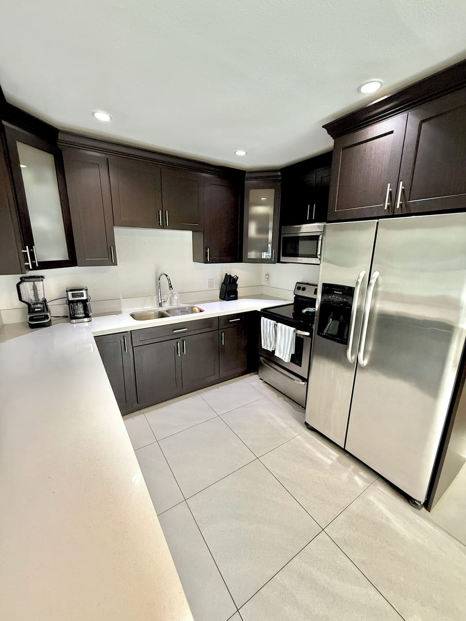 Side by side refrigerator with filtered water dispenser and ice maker.