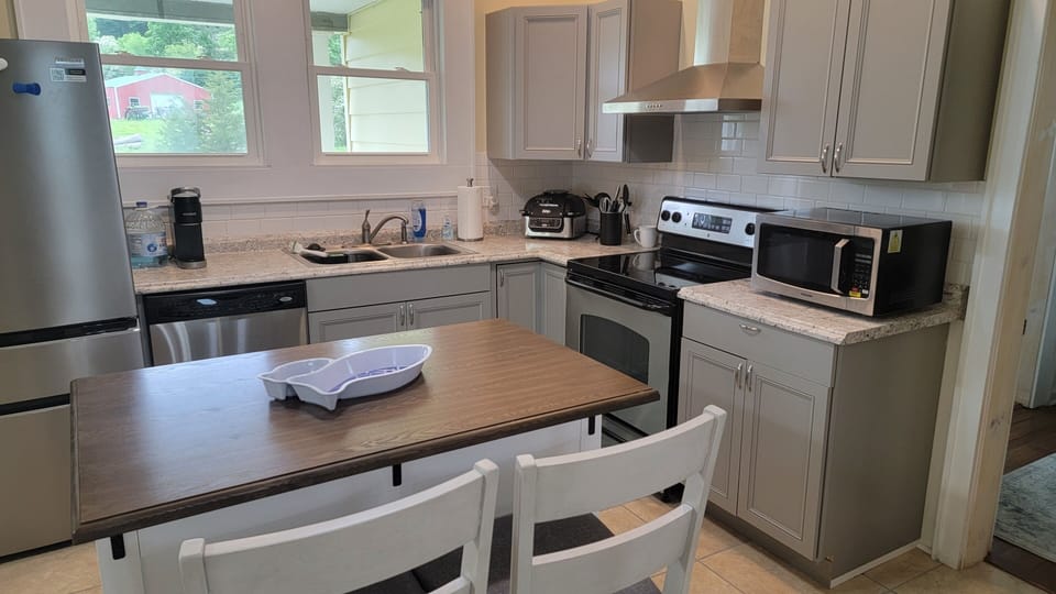 kitchen has new refrigerator, electric range, microwave, Keurig, Ninja air fryer