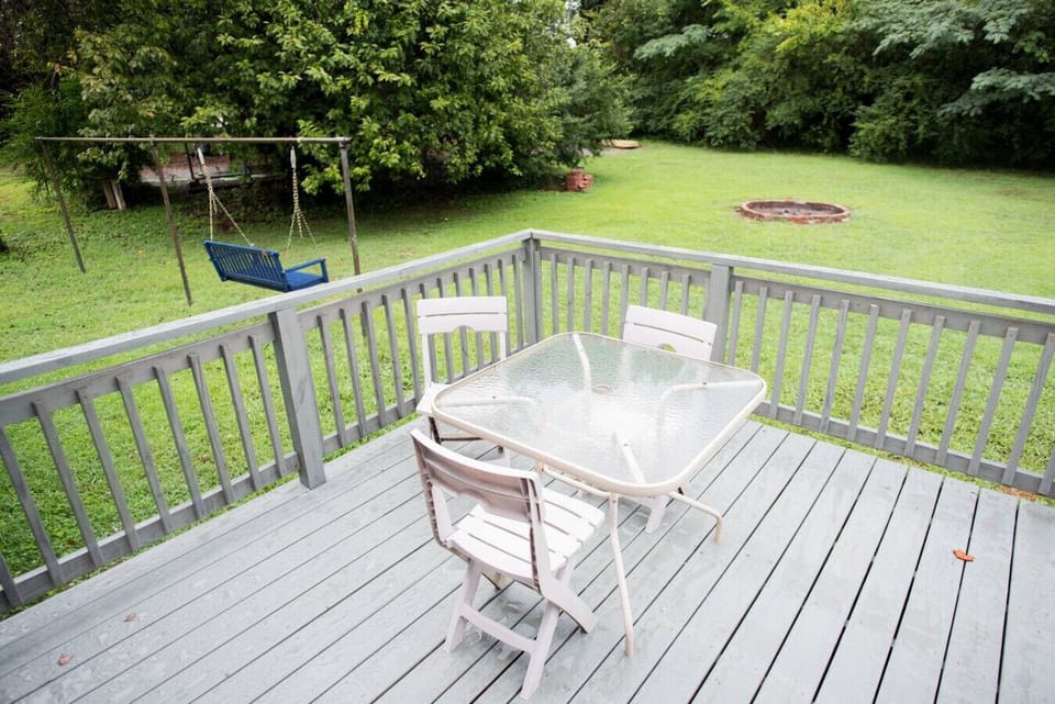 View from back patio/french doors with fire pit and wooded backyard.