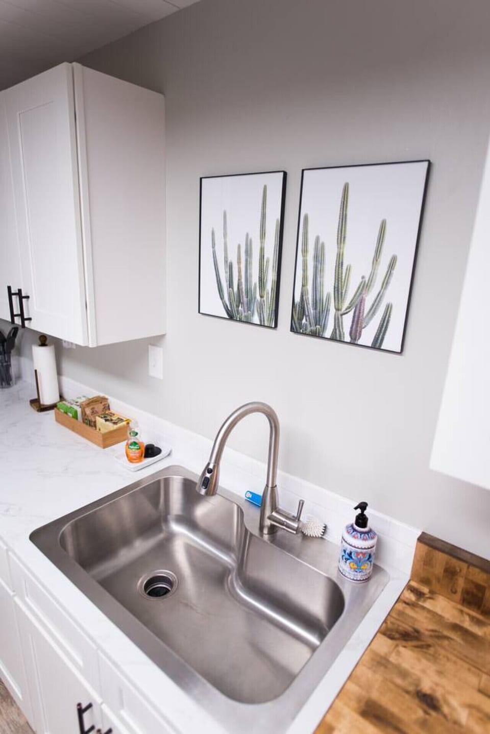 A unit kitchen with fully stocked bakeware, serve ware, and multiple appliances