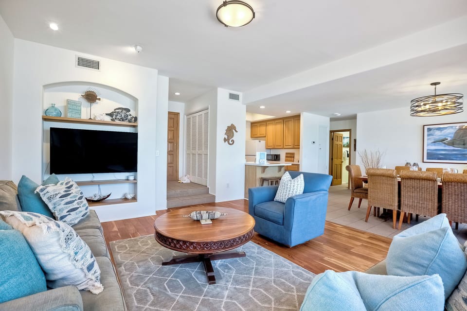 Relax in the beachy living room of the lower unit.