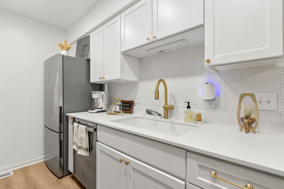 Quartz Countertops and Bright White Cabinetry in the Kitchen