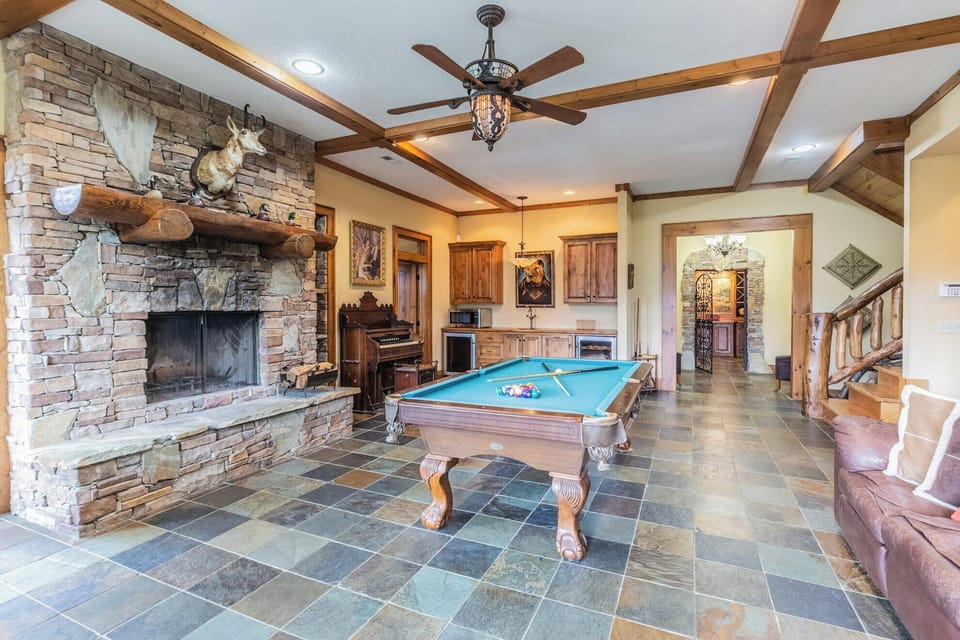 Rustic retreat, game-ready! This charming game room offers a cozy atmosphere and plenty of space for fun and relaxation.