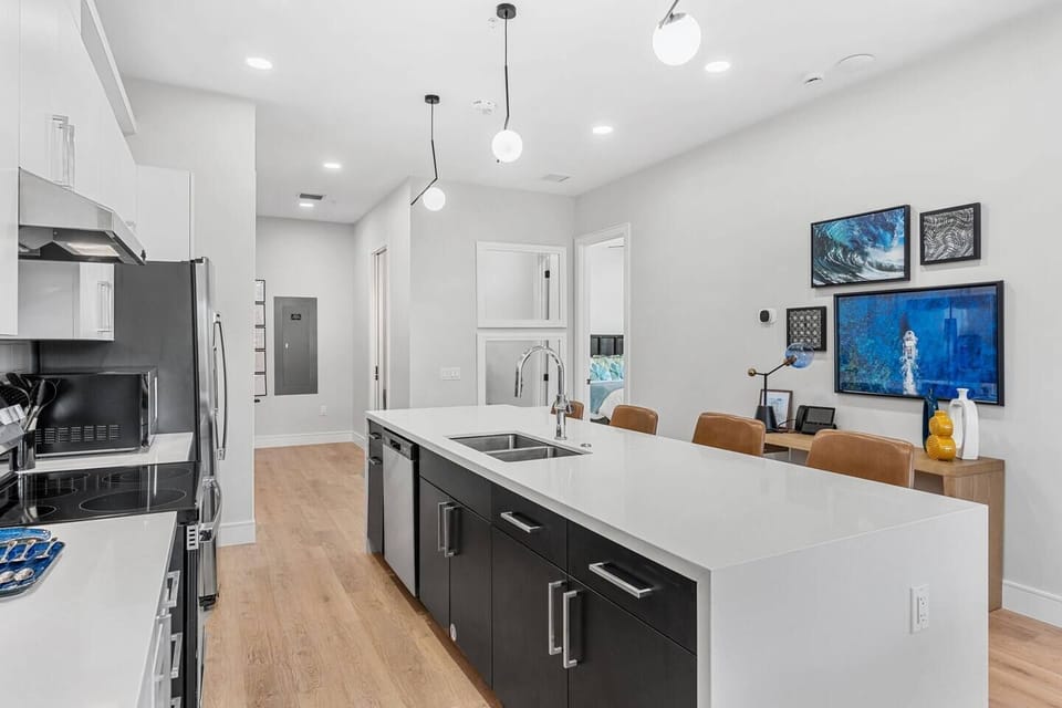 Spacious kitchen with a central island for gathering and dining.
