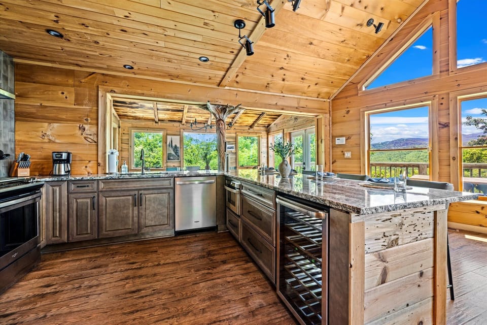 Whether you're making breakfast or enjoying a glass of wine, the kitchen island gives you front-row seats to the beautiful Smoky Mountain scenery through our massive windows. 
