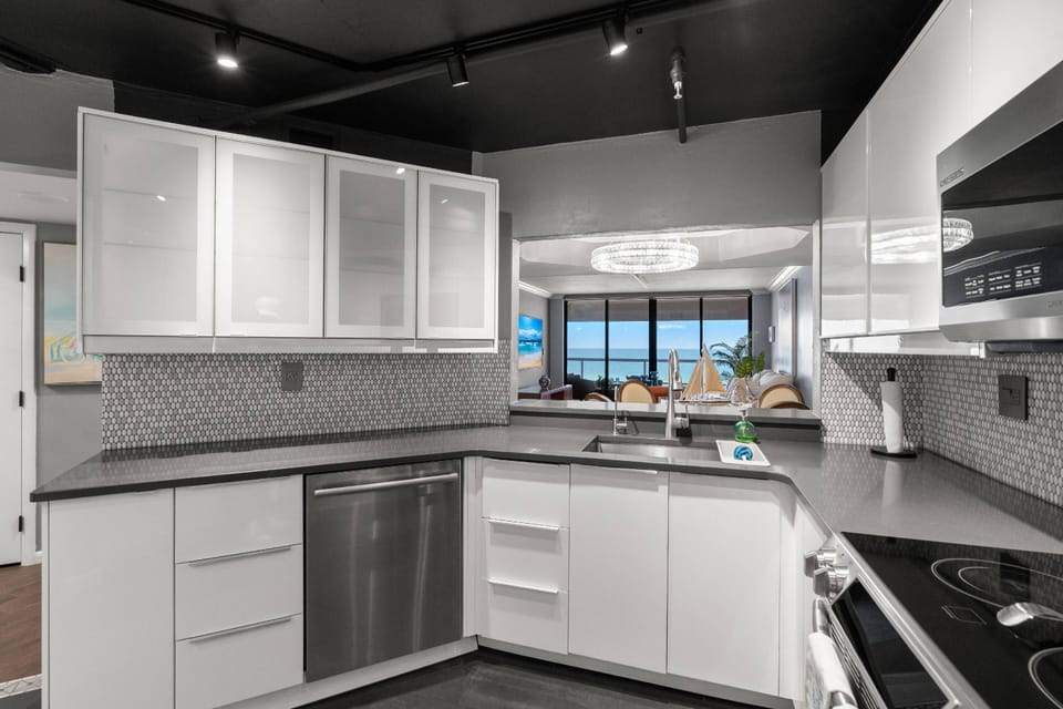 Updated, Fully Equipped Kitchen with Sleek White Cabinets and Stainless-Steel Appliances