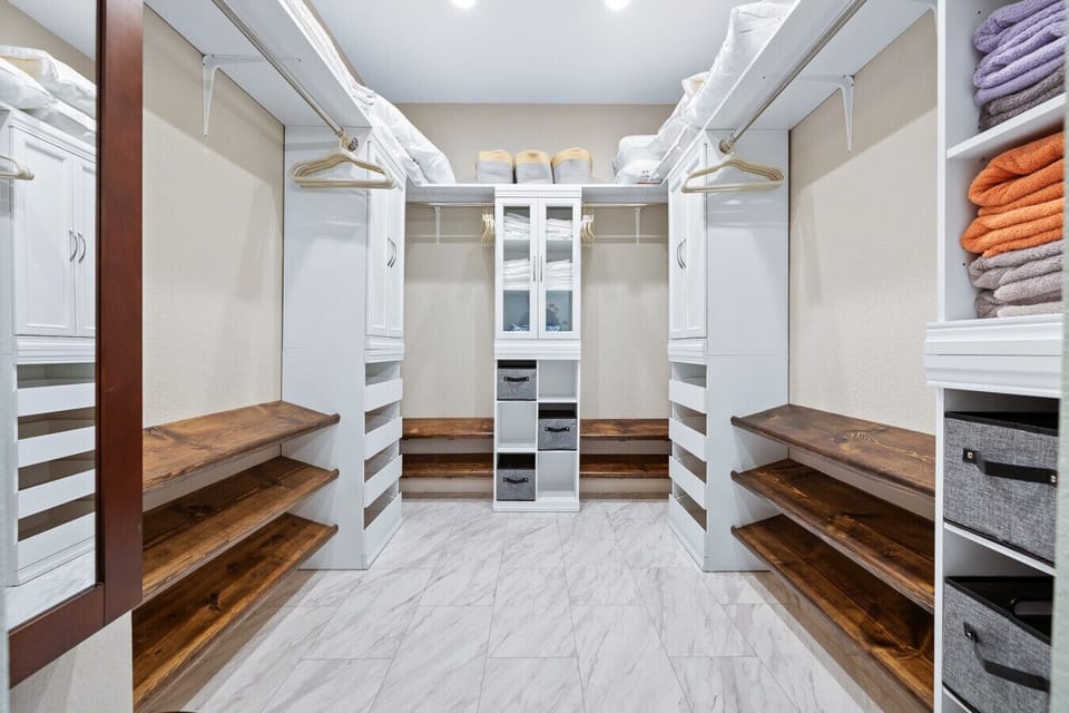 This property offers a versatile bedroom featuring comfortable beds and is complemented by an expansive walk-in closet for ample storage.