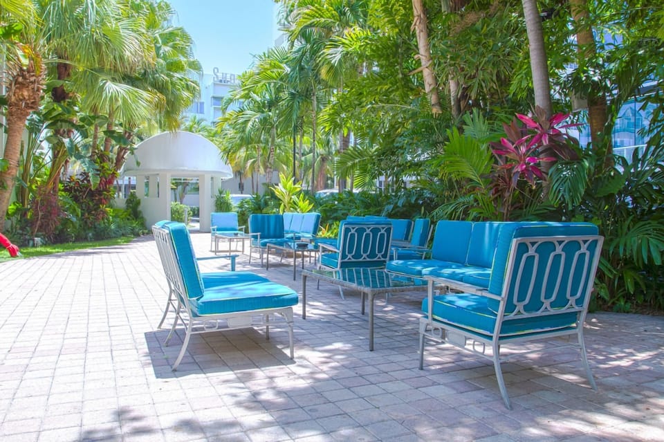 Stretch out on plush loungers in a sunny, tropical patio.