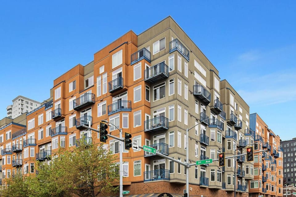 Modern and secure condo building in downtown Seattle with private balconies and vibrant architectural design.