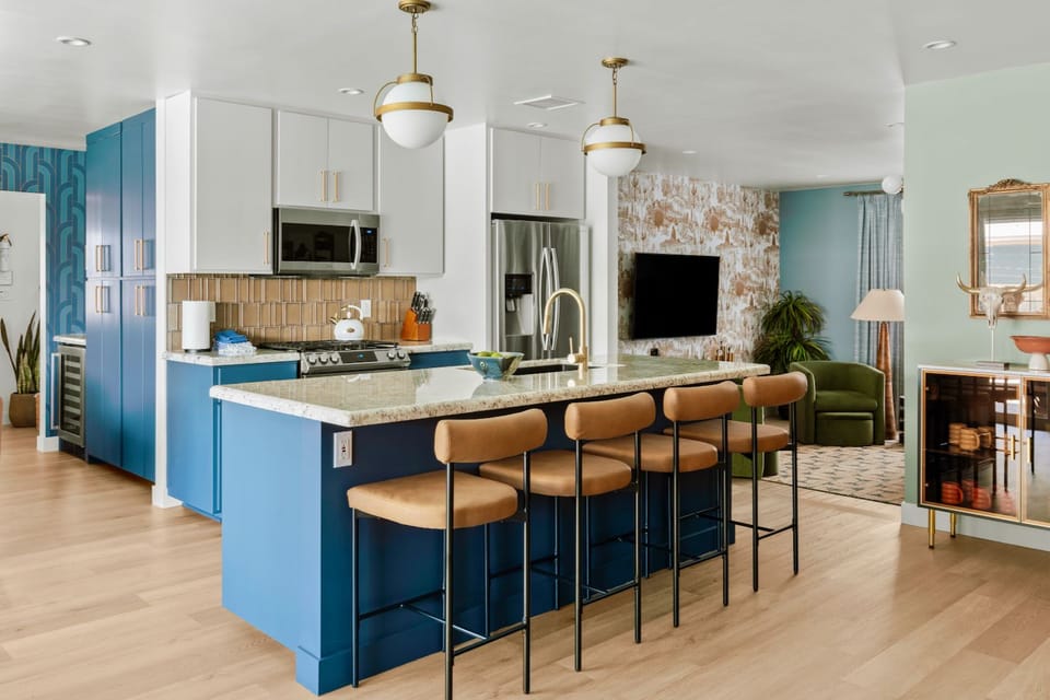 Stylish open kitchen with large island seating and chic modern lounge