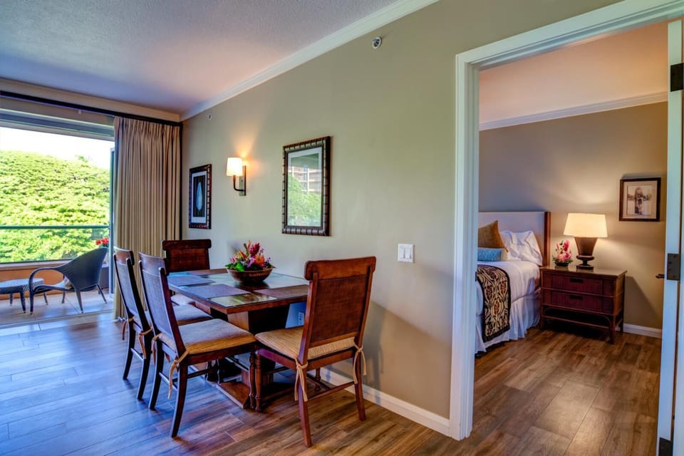 Elegant dining area and cozy bedroom with tropical garden views. HKK-242