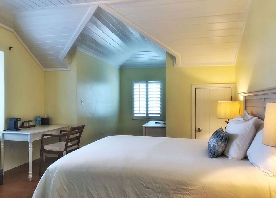 Sink into plush king linens under warm, calming lamplight.