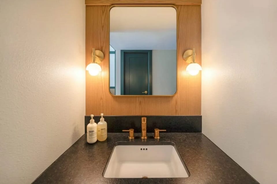 Start your morning at a sleek vanity with warm lighting.