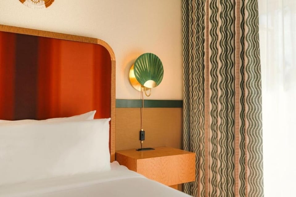 Relax by the bedside with soft lighting and calming textures.