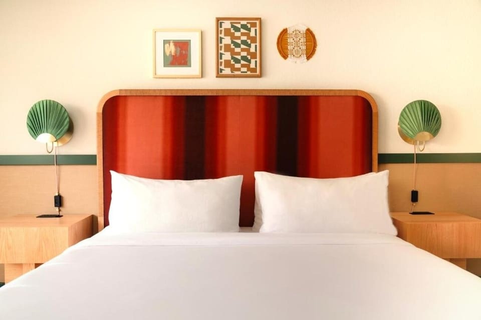 Sink into crisp linens beneath a bold, designer headboard.