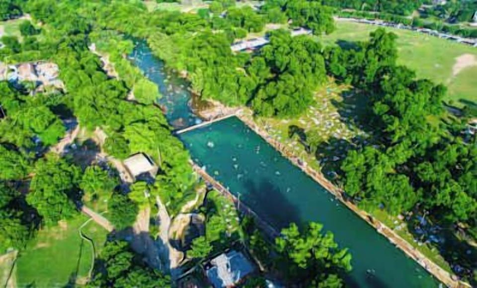 Barton Springs Pool is a three-acre underground spring-fed pool that remains at a constant temperature year-round, located within Zilker Park.