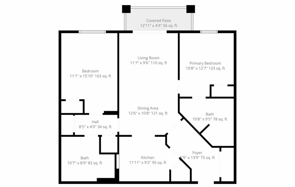 Easy 2BR/2BA layout: primary king suite, guest room with two full-size beds, open living/dining, and a covered patio.