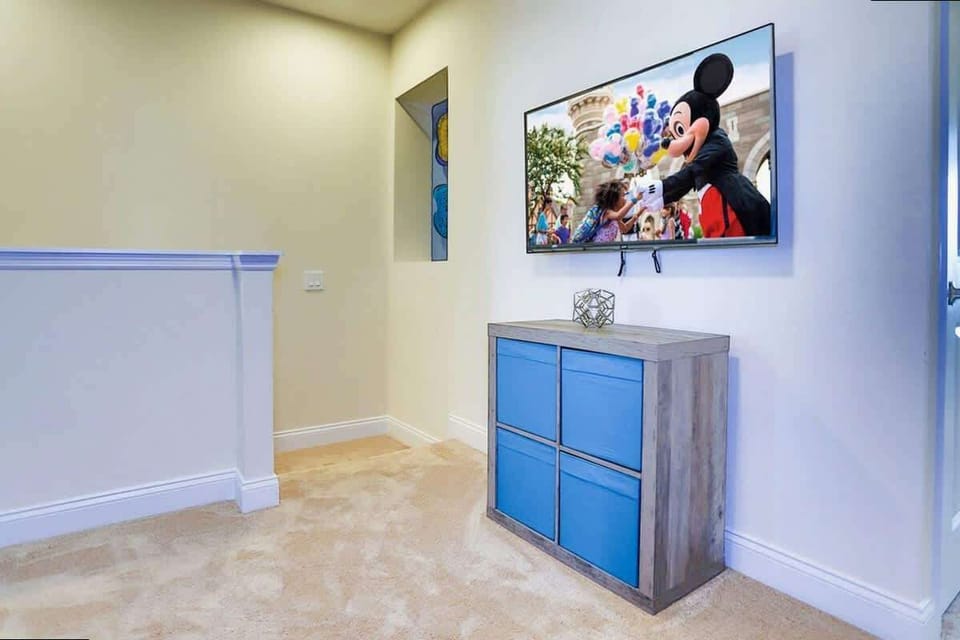 Upstairs, find a cozy loft lounge with a TV and playful decor-a perfect hangout spot for movie nights!