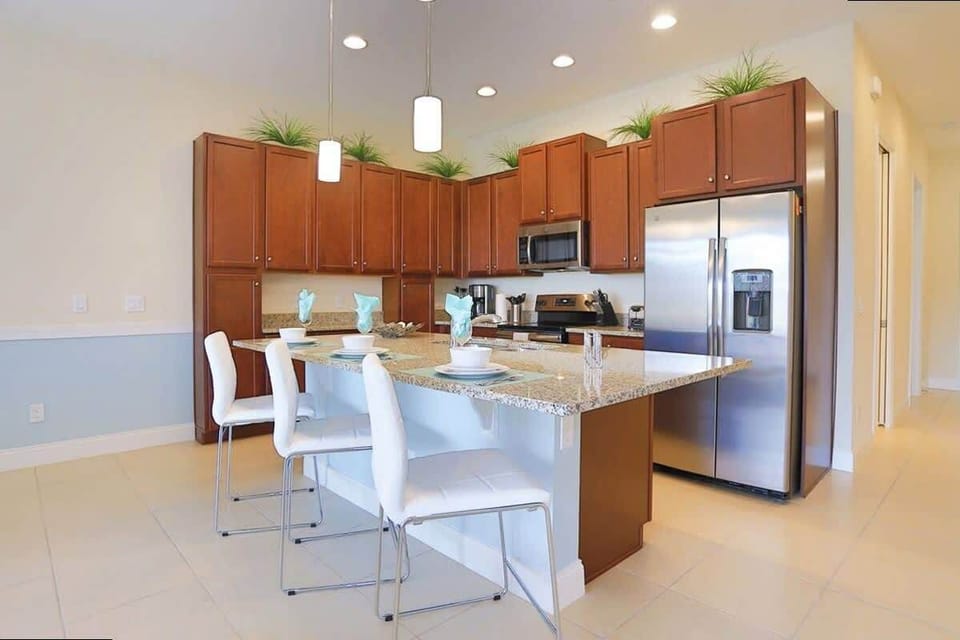 Cook up memories in this modern kitchen featuring granite counters, stainless steel appliances, and a breakfast bar with seating for four!