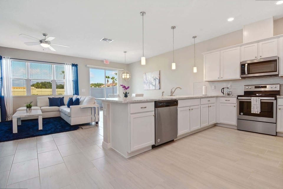 Cook and connect in this sleek, modern kitchen with stainless steel appliances, granite countertops, and an open floor plan flowing into the stylish living space.