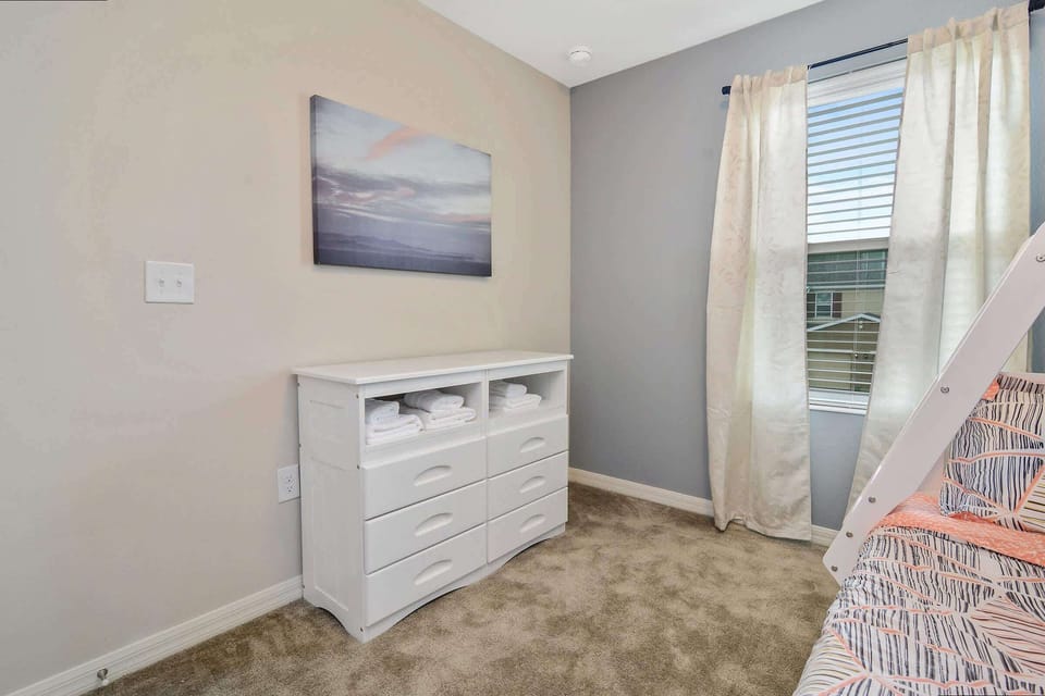 Stay organized with this bright, cozy corner featuring a handy dresser stocked with fresh towels-perfect for a comfortable and convenient stay.
