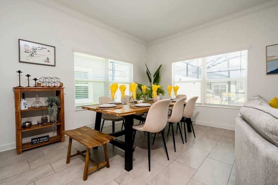 Host family feasts or game nights in this bright dining area with a rustic wooden table, comfy seating for eight, and cheerful decor for memorable gatherings.