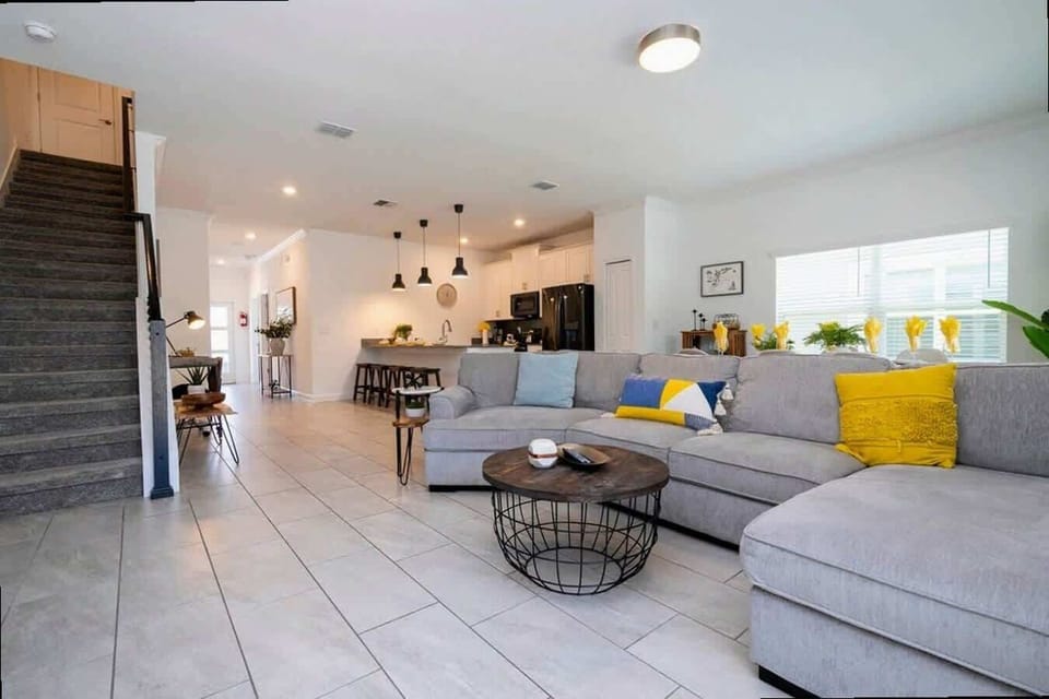 Gather in this bright, modern open-concept living area with a cozy sectional and stylish decor-perfect for relaxing and connecting with loved ones after a day of adventure!