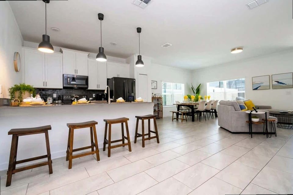 Share meals and memories in this open-concept kitchen, dining, and living space-sleek finishes, ample seating, and a warm, inviting vibe make entertaining a breeze.